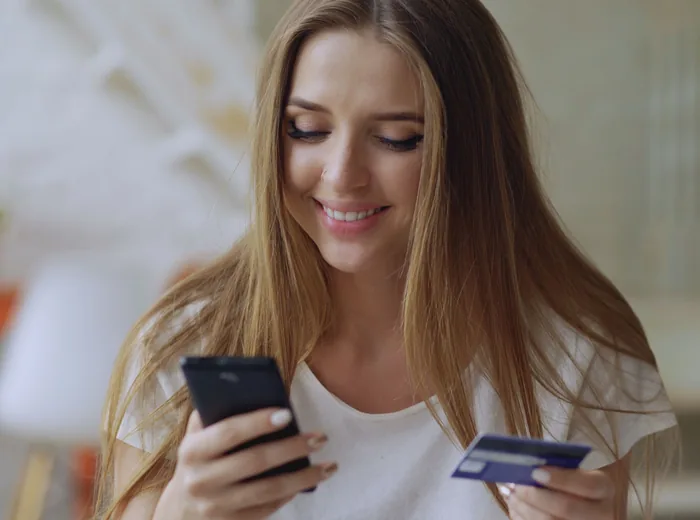 Patient checking Alphaeon Credit approval on a smartphone