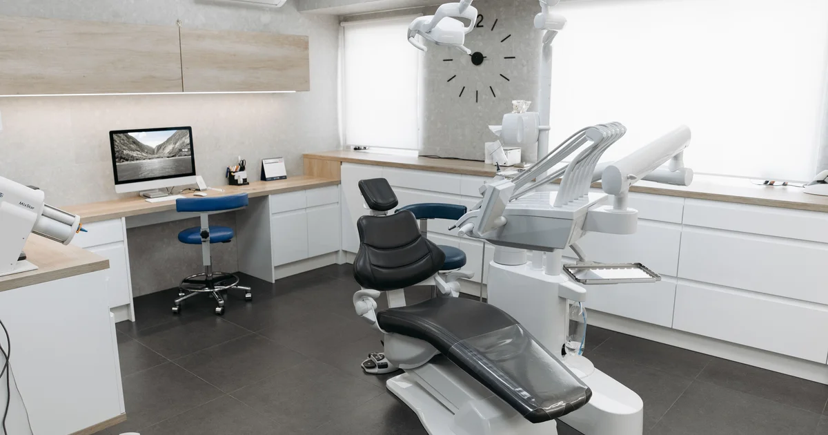 Dentist performing dental implant procedure financed by Alphaeon Credit